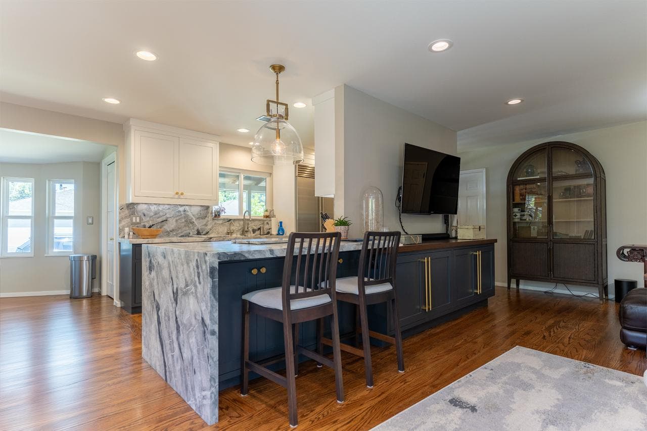 Full home remodeling with open concept kitchen flowing into living room with abundant natural light