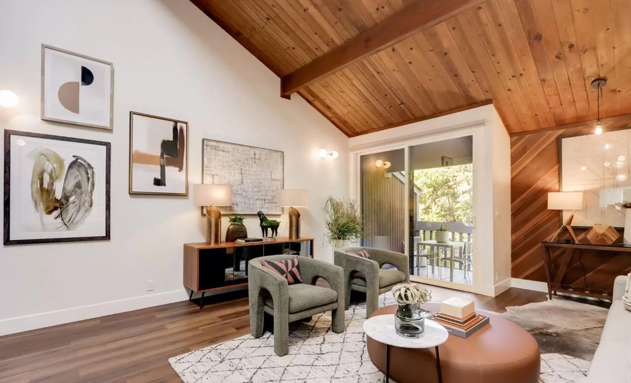 Luxury home remodeling San Francisco living room with vaulted wood beam ceiling and floor-to-ceiling windows for indoor-outdoor living